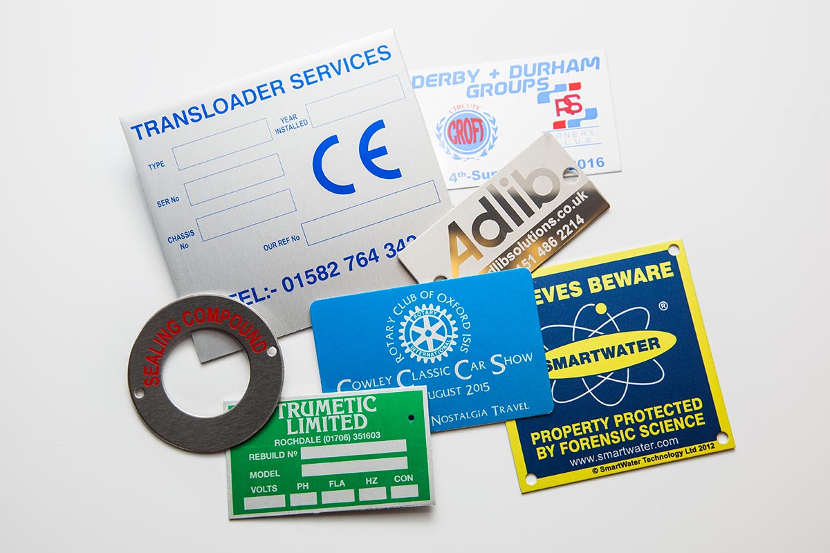 several colour custom metal labels of varying shapes and sizes