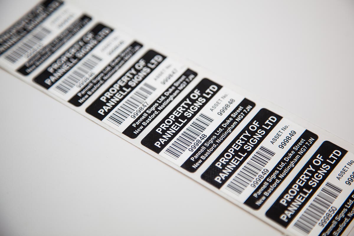 sheet of black and white barcode labels identifying ownership