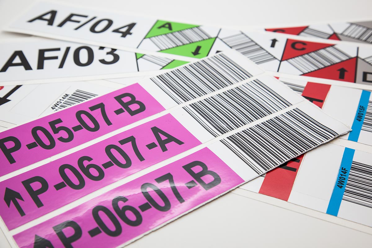 several sheets of full colour stocking and barcode laminated labels